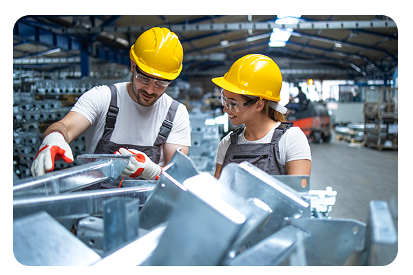 two frontline manufacturing employees engaged and happily working